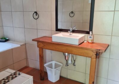 Cozy Bathroom with Classic White Fixtures and Tiled Walls