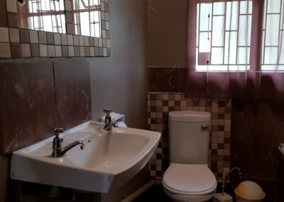 Cozy Bathroom with Classic White Fixtures and Tiled Walls