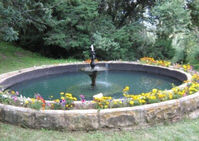 Stone Garden Fountain with Flower Border