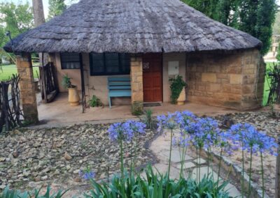 rustic Stone Lodge with Thatched Roof and Outdoor Seating